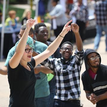 A group of students cheer and dance during the fall Cavalier Kickoff event.